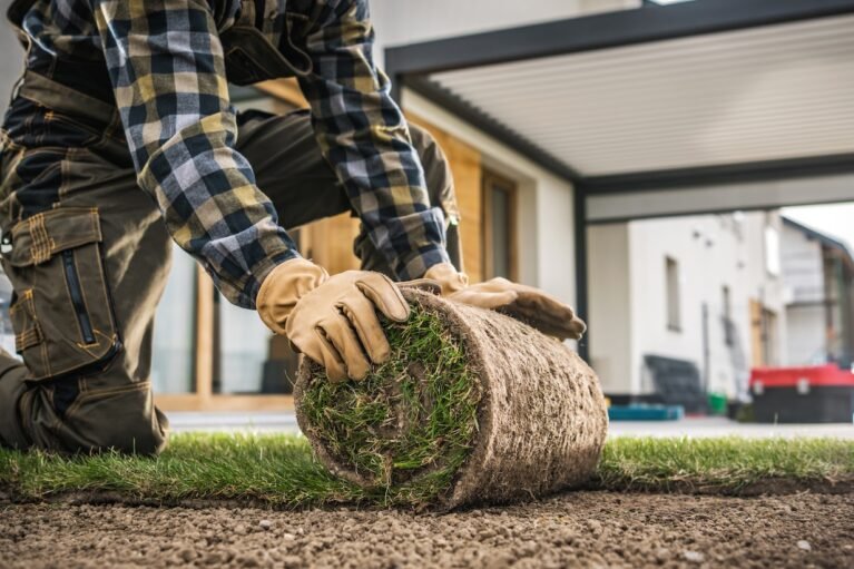 caucasian-landscaper-installing-roll-of-new-natura-2026-01-09-01-09-03-utc